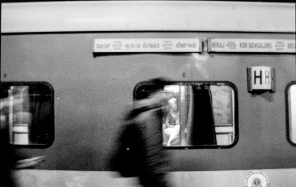 I really liked this one. I took this at Bangalore Railway station. I had envisioned something like this, with a motion blur juxtapositioned against the elder man looking outside - happy it came out good.