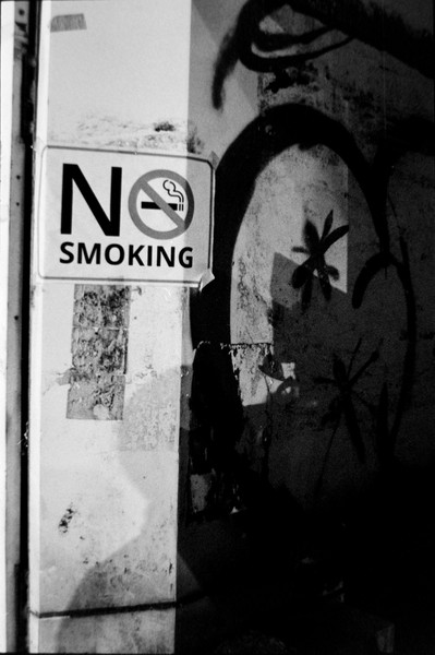 This was late in the evening, beside a cigarette vendor. I wanted to capture that with a shadow of person smoking, but could only get my torso